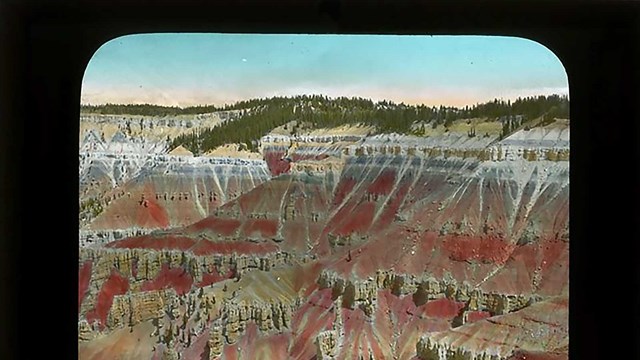 Old color slide image of Cedar Breaks cliffs - hand painted in pink and orange.