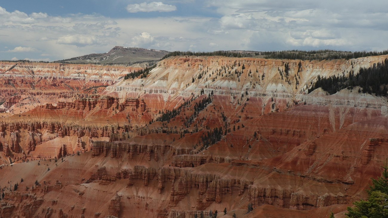 Clouds loom over the snowy Cedar Breaks Amphitheater