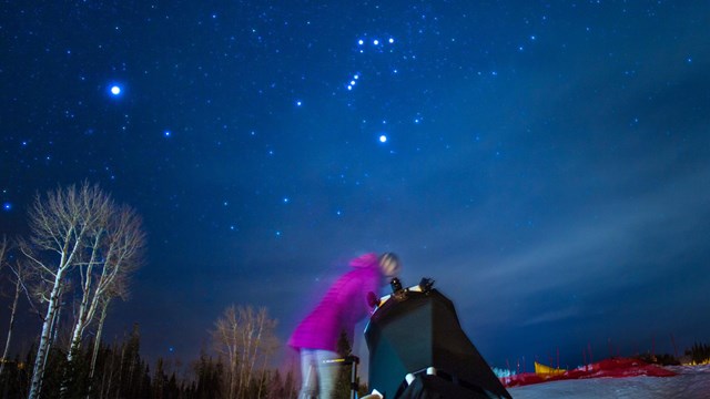 A park visitor peers into a telescope for a closer view of the stars during an astronomy program.