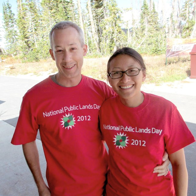 A couple wearing shirts that say 