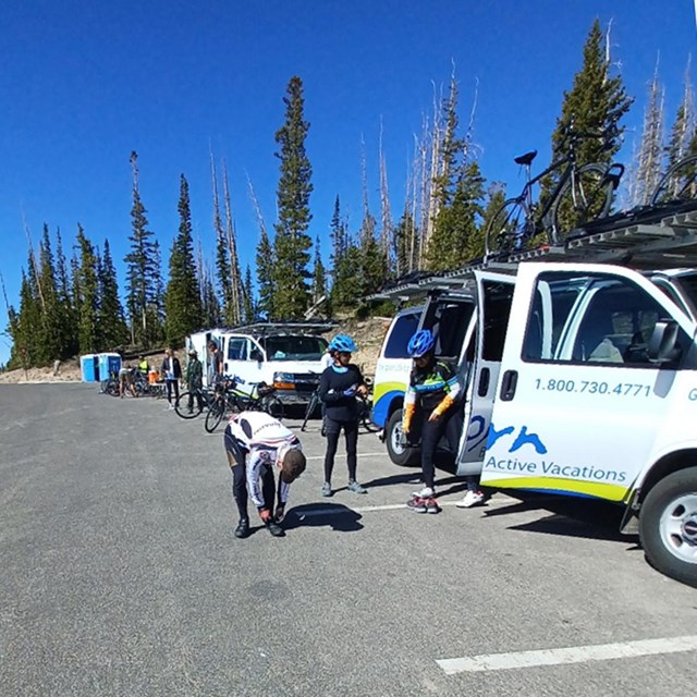 A group of bicyclists prepare to set off with a commercial group.