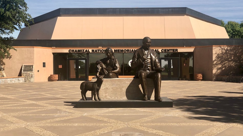 A sculpture with three figures sits on the esplanade in front of the Chamizal Cultural Center