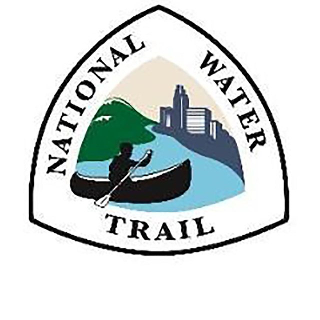 NWT logo with person paddling a canoe, green hills on left & high-rise buildings on right. 