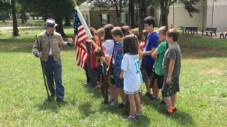Park ranger leading a living history program for kids