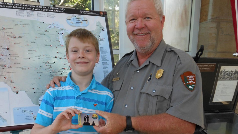 A park ranger presents a 4th grade pass