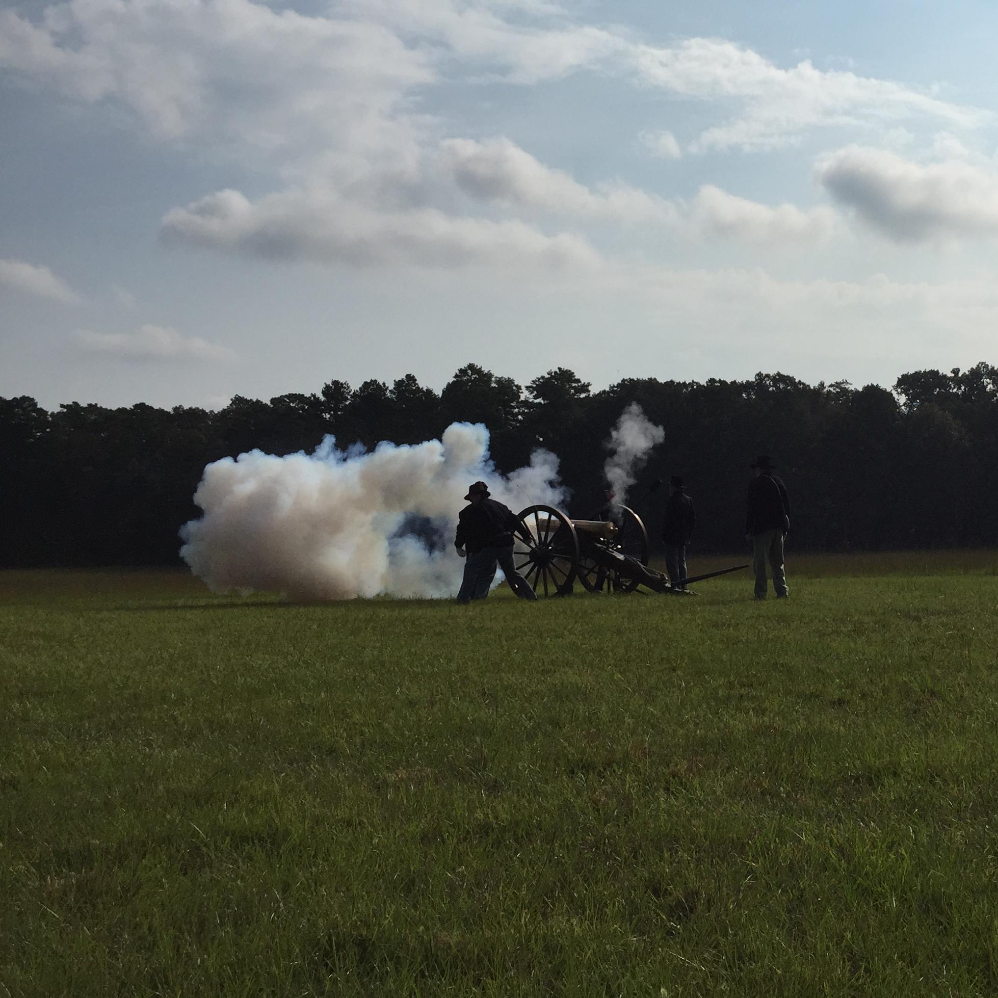 Living historians fire a reproduction cannon
