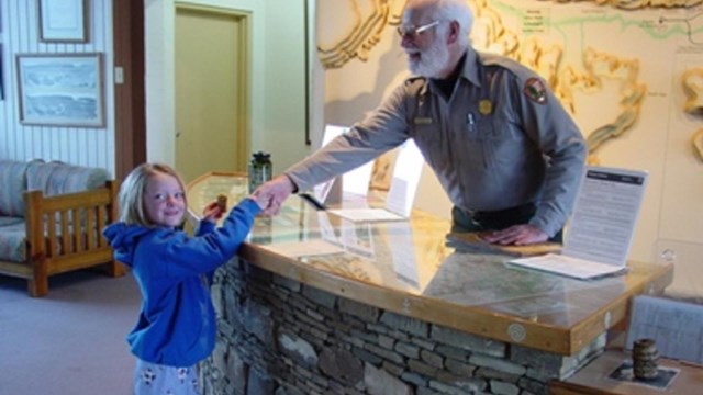 Prairie Bergman gets her Junior Ranger badge.