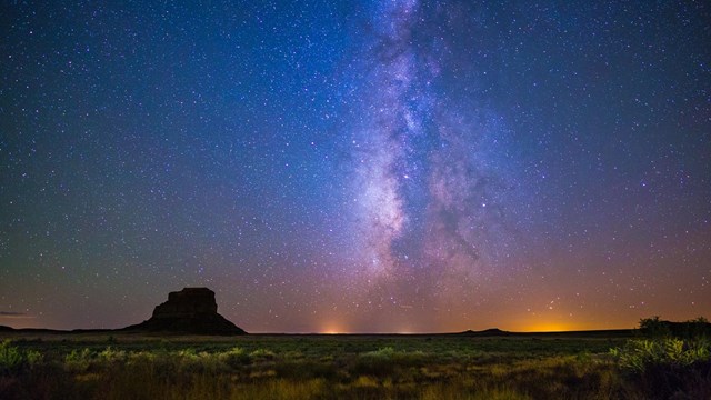 The night sky showing a mixture of orange, purple, blue, and white colors mixing together.