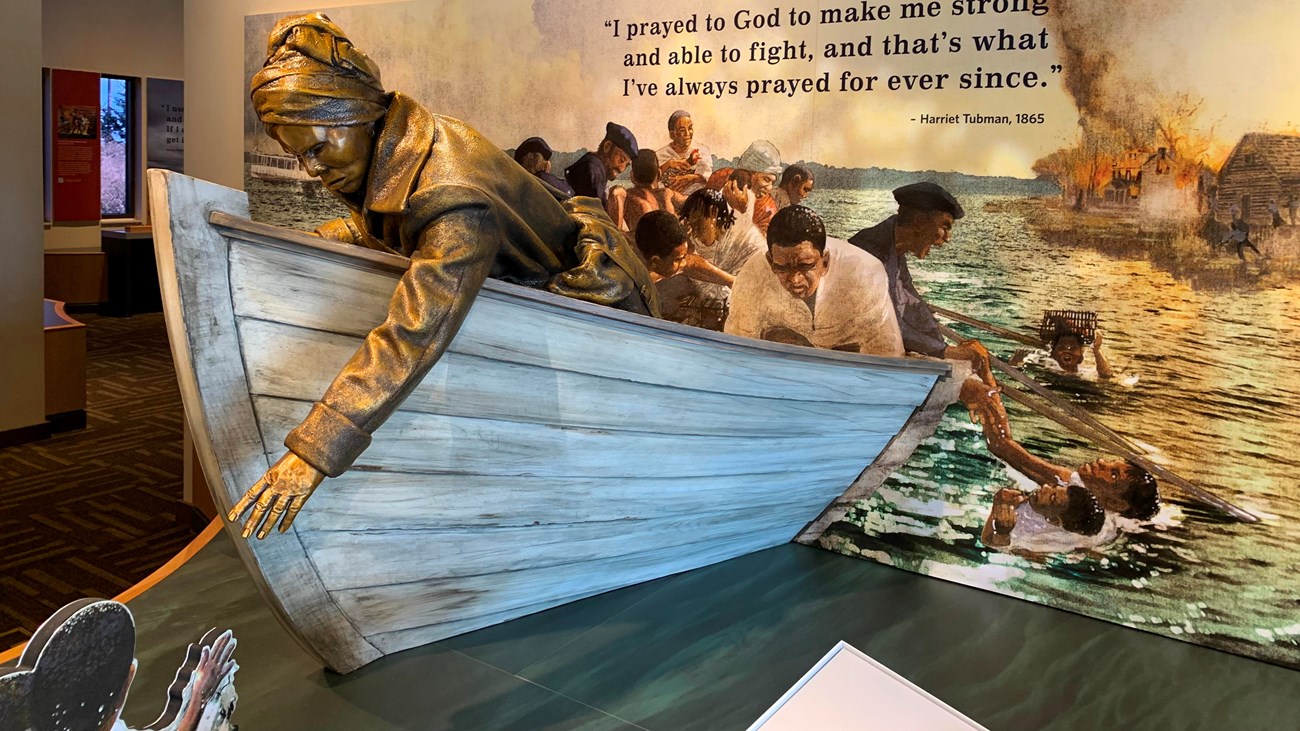 Museum exhibit depicting Harriet Tubman rescuing people from water.