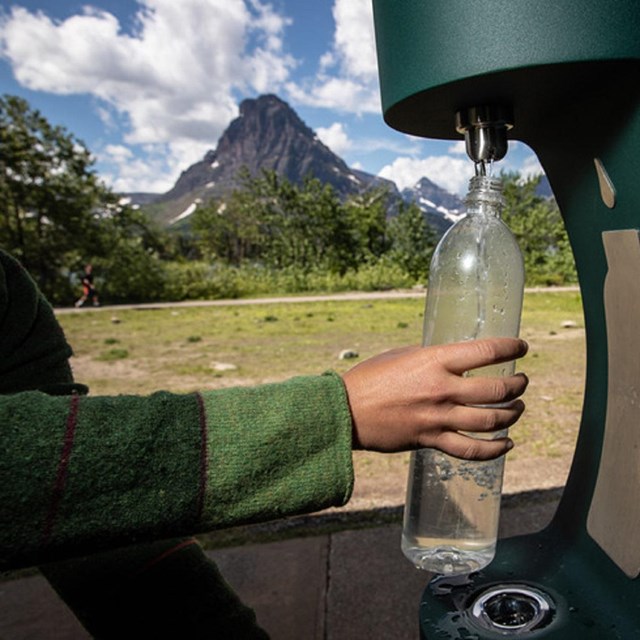 a water bottle filling station is used to refill a water bottle