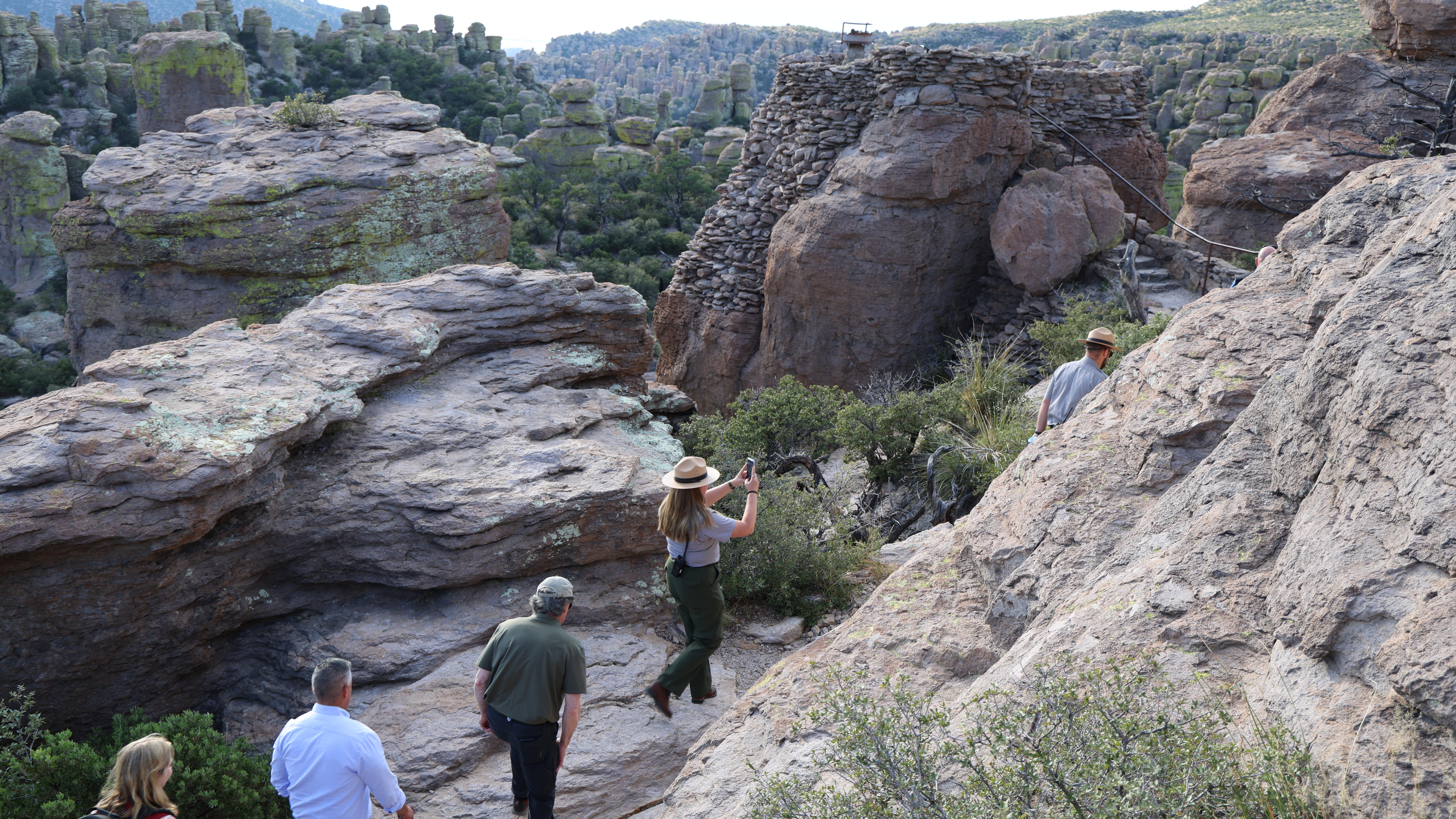 hikers walk between rocks at massia point
