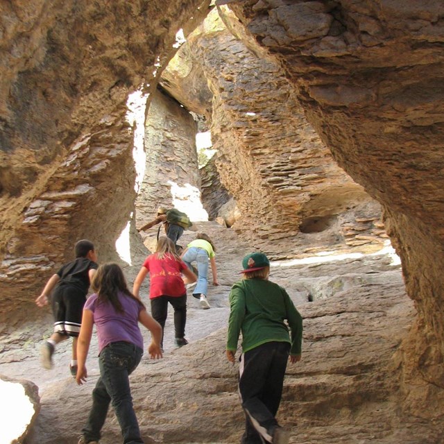 Kids play in a rock grotto