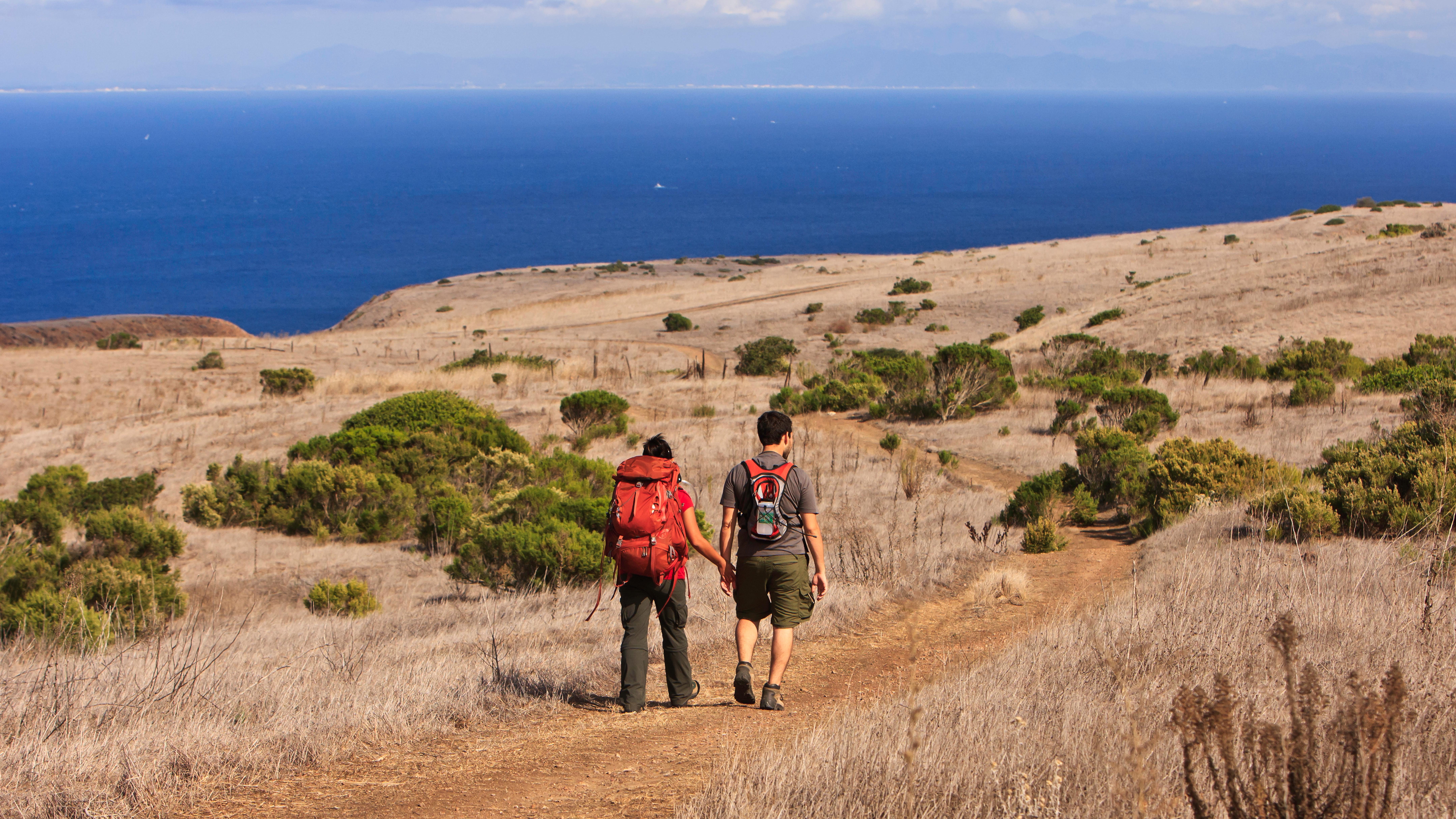 Visitors hiking on trail with view of ocean. &copy;Tim Hauf, timhaufphotography.com