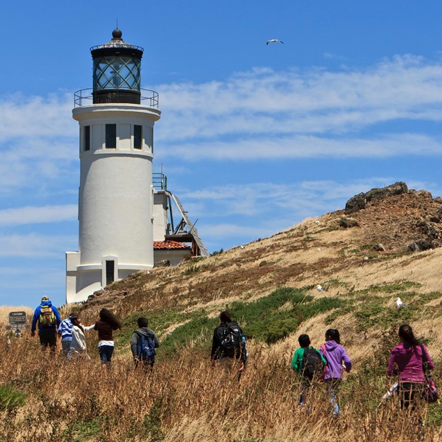 Visitors hiking towards lighthouse. ©Tim Hauf, timhaufphotography.com
