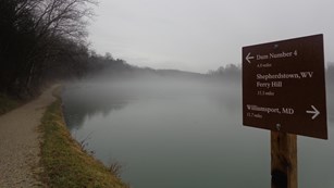 The Potomac River flowing calmly on a misty day.