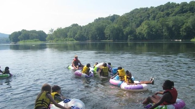 Youth with chaperone enjoying tubing.