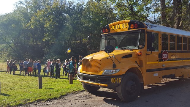 A school bus is parked at the C&O Canal