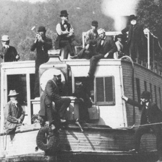 Historical black and white photo of canallers aboard a canal boat.