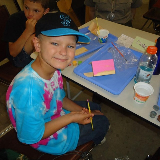 Youth engaged in an art activity during a Junior Ranger program.