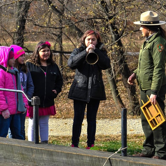 Three children and a park ranger