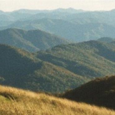 A scenic view of mountains and blue skies.