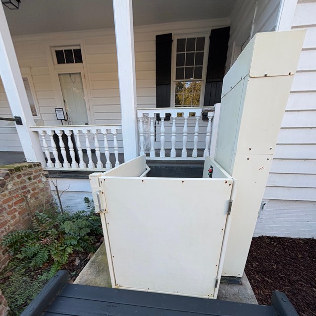 A small single-user lift to get from the ground level up onto the porch of the home.