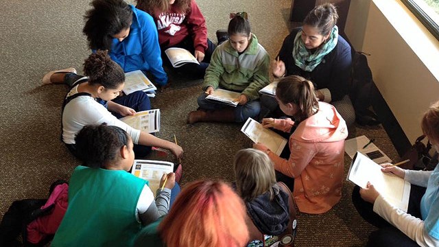 Youth work on their Junior Ranger books in the park's visitor center.