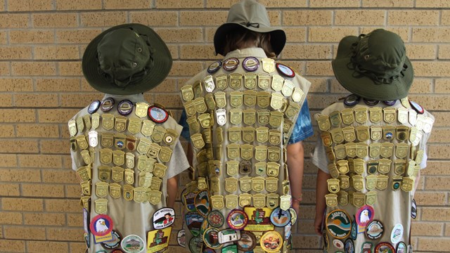 Young children showing off Junior Ranger Badges.