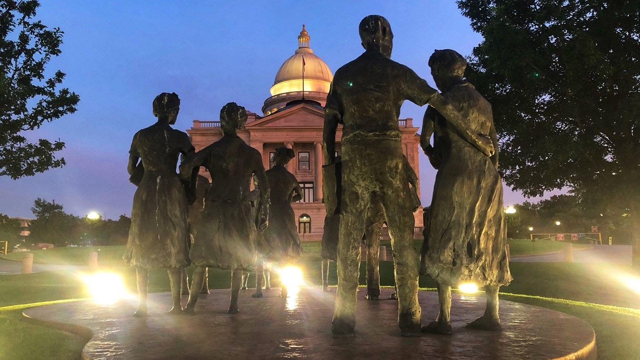 Bronze statues of nine African American students, known as the Little Rock Nine.