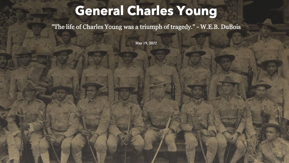 A portrait of several army soldiers sitting and text on top reading General Charles Young