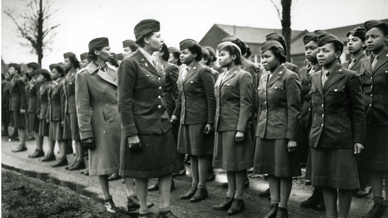Black and white photo of African American women army officers inspecting their troops in World War 2