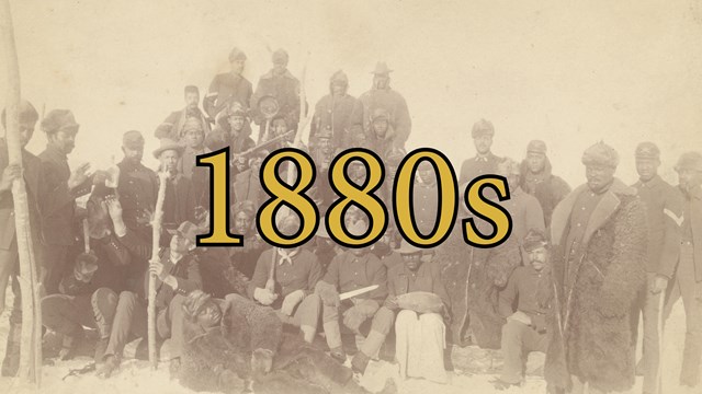 Sepia colored photograph with African American soldiers standing in three rows. 1880s is written