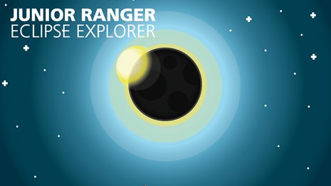 The Eclipse Explorer booklet showing the moon passing in front of the sun over a mountainous terrain