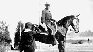 Mounted cavalry officer saluted by child