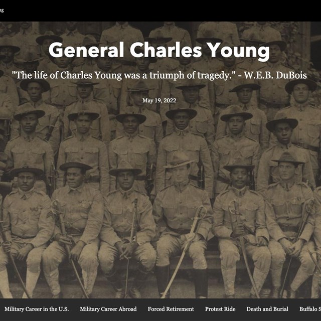 A portrait of several army soldiers sitting and text on top reading General Charles Young