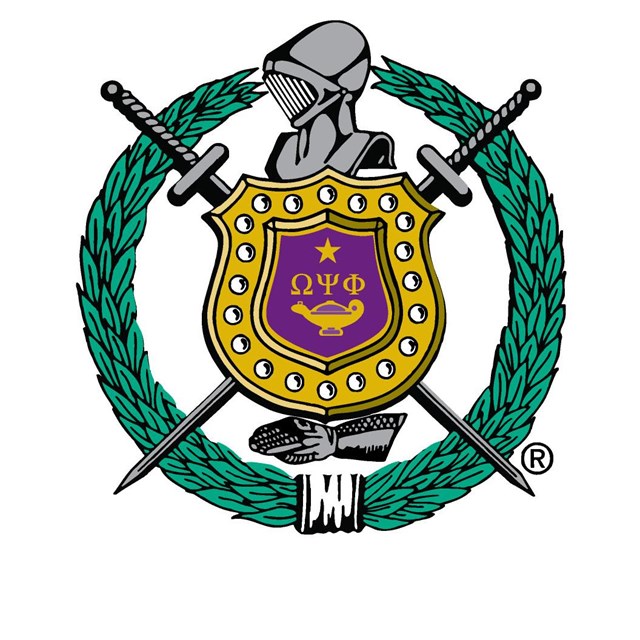 A circular wreath with two swords in the background and a knight's helmet in the center above shield