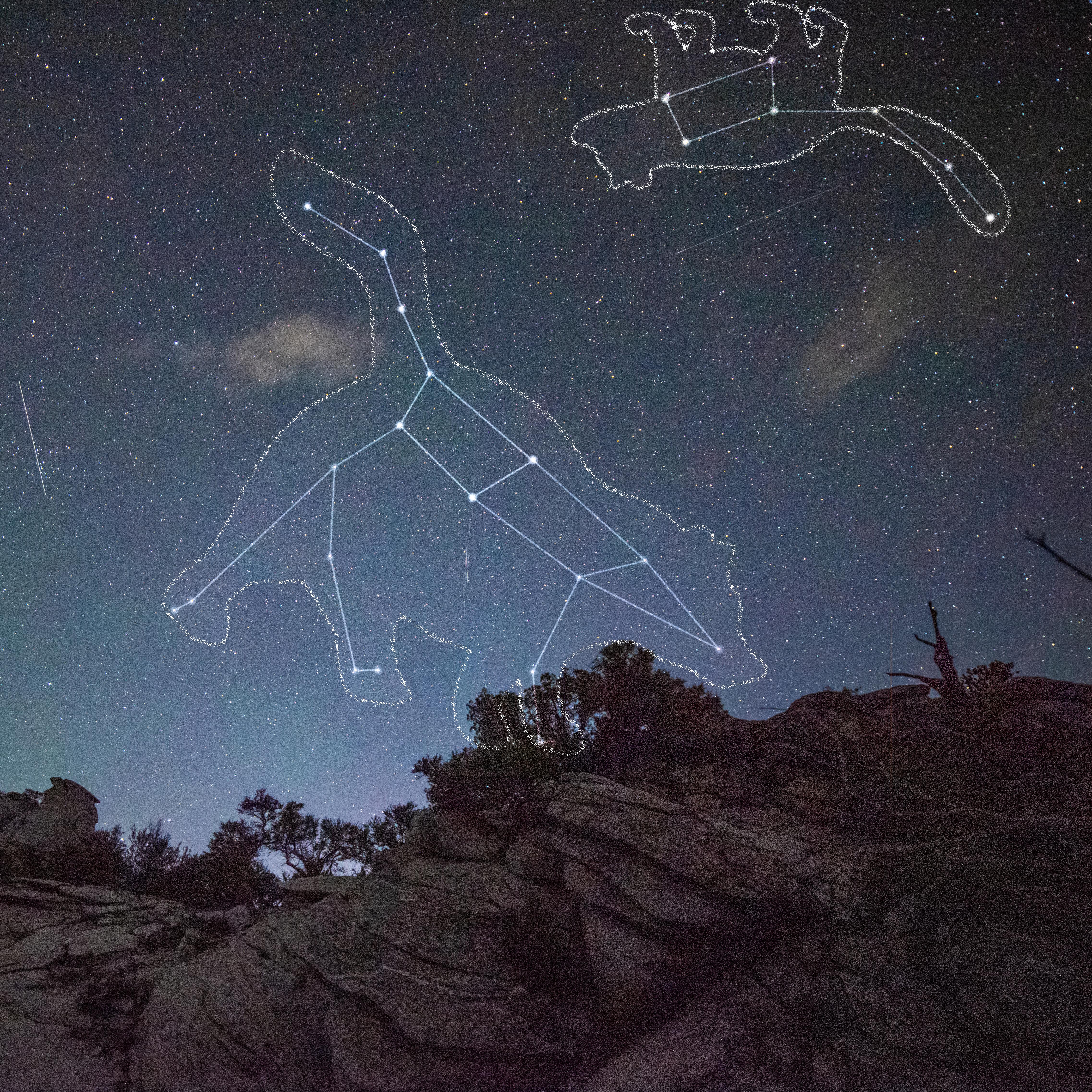 The Milky Way blazes across the dark sky over the silhouette of a rock formation.