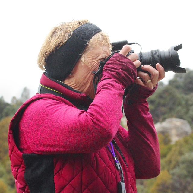 Close up of a photographer preparing to take a picture.