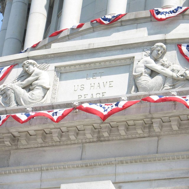 a white columned memorial with red, white and blue bunting