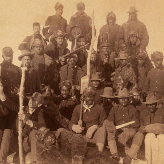 sepia photo of African American soldiers in group