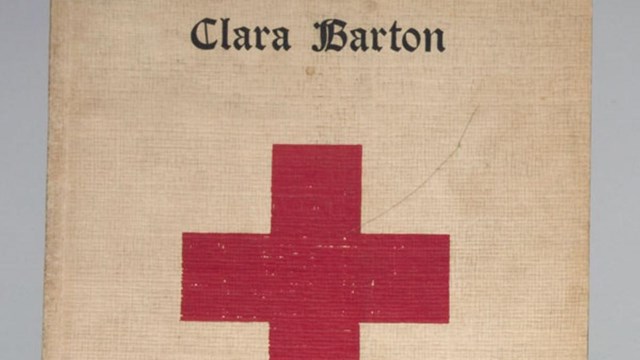 A red cross book with the words Clara Barton