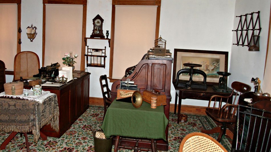 old fashioned roll top desks and furniture in turn of century office setting