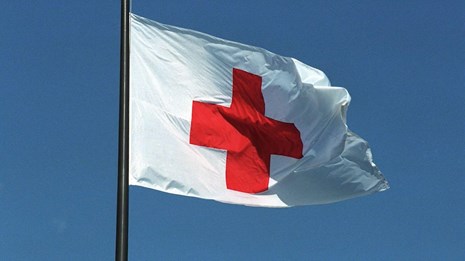 A white flag with a red cross.