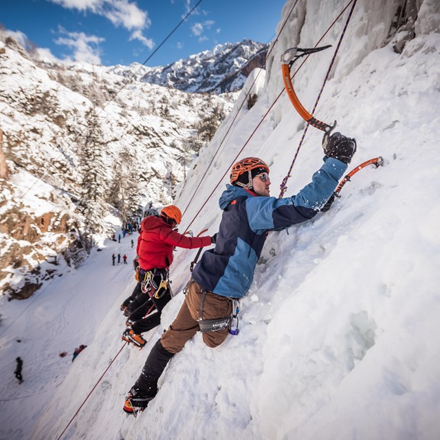 An adaptive climber, he is has a limb amputation, ice climbing.  
