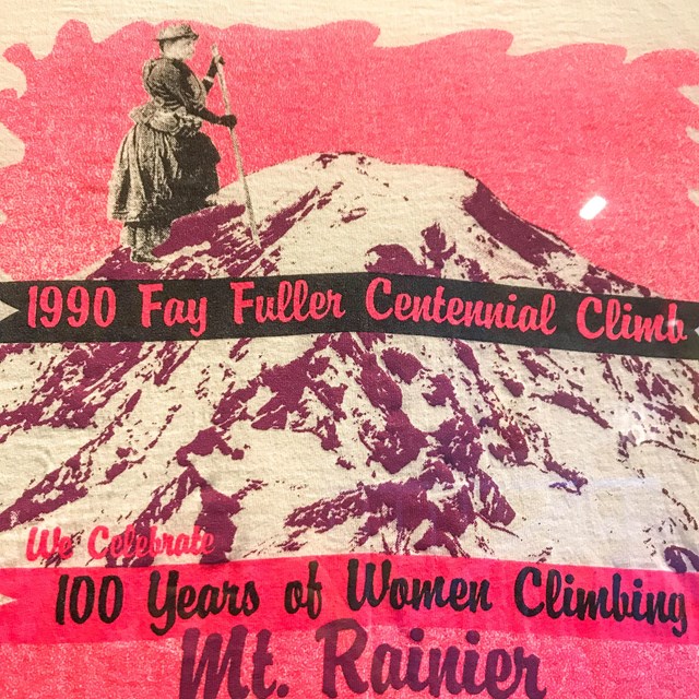 Colorful cartoon poster of a woman summiting Mt. Rainier in a dres..