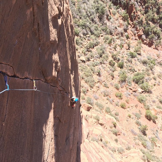 climber following up a traditional red standstone crack. 