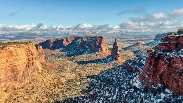 bright, colorful canyons with snow in the shade beneath cliffs