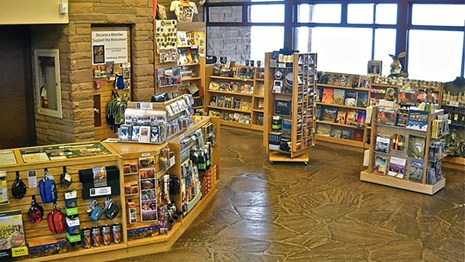 Bookstore showing display shelves full of merchandise including books, maps and other supplies.