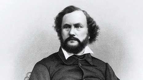 An engraving of Samuel Colt. Older man with beard.