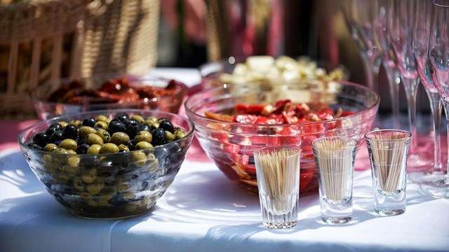 Food served on a table with toothpicks and empty glasses